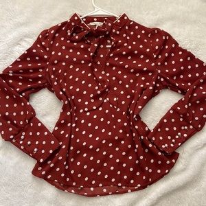 Polka dot blouse, pearl buttons on the sleeve.